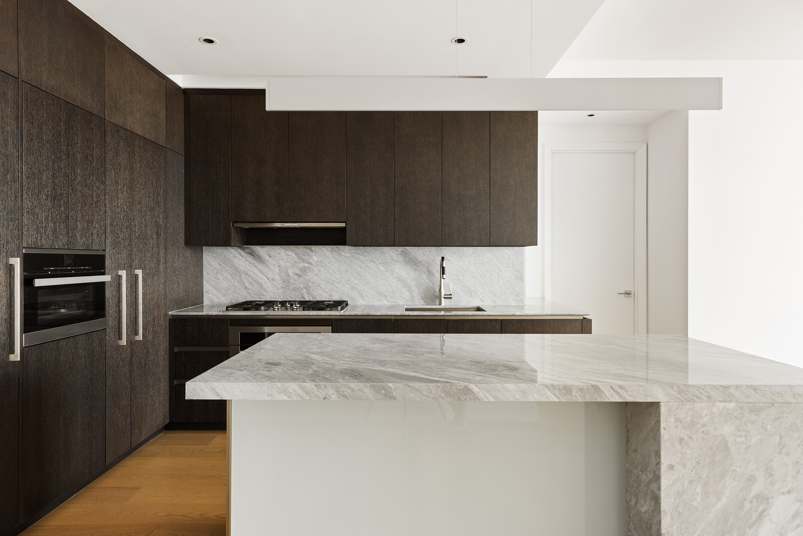 15 Hudson Yards, Unit 68C Manhattan, NY 10001 - Photo 7 of 16 a kitchen with granite countertop a stove and a refrigerator