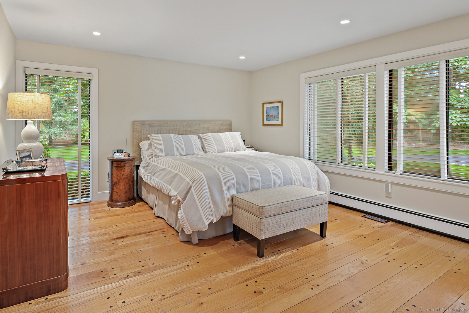 13 Bittersweet Road Weston, CT 06883 - Photo 15 of 35 a bedroom with a bed and large windows