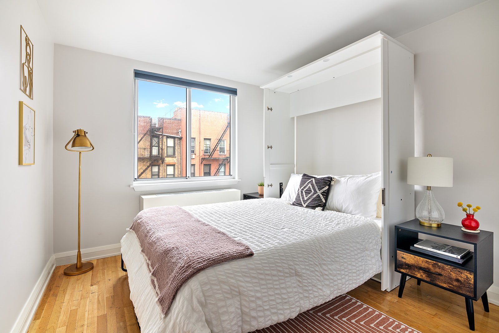 447 West 45th Street, Unit 5A Manhattan, NY 10036 - Photo 7 of 12 a bedroom with a bed and a window