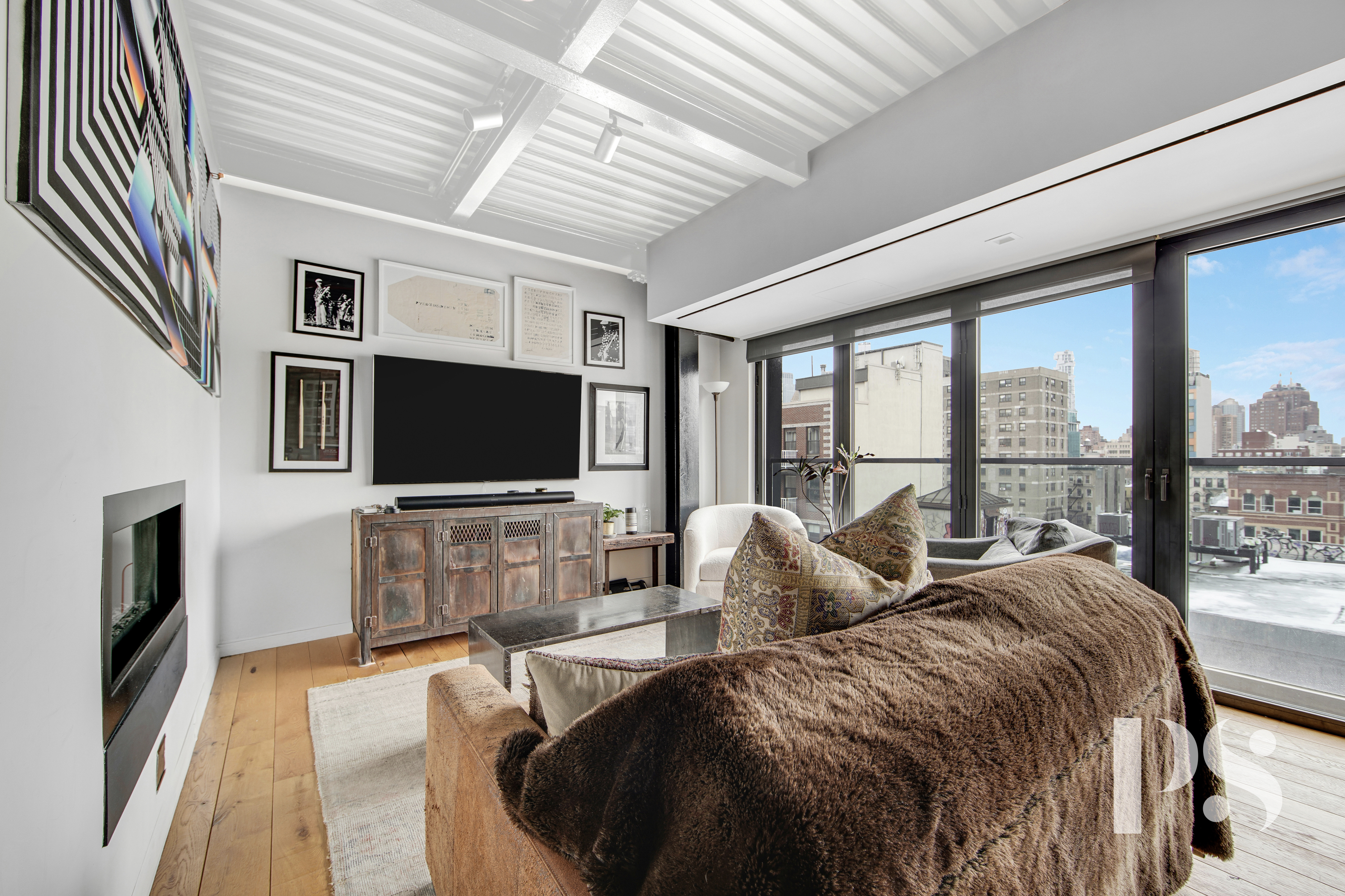60 Orchard Street, Unit PH Manhattan, NY 10002 - Photo 3 of 19 a living room with a large window and a flat screen tv