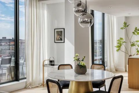 a view of a dining room with furniture and window