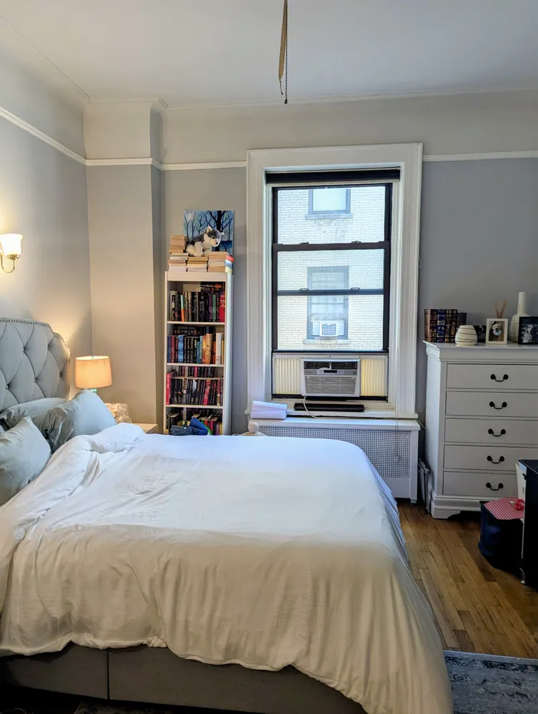 a bedroom with a bed and dresser