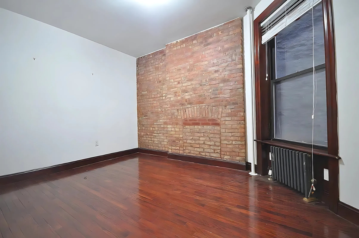 422 Amsterdam Avenue, Unit 3A Manhattan, NY 10024 - Photo 5 of 11 a view of an empty room with wooden floor and a window