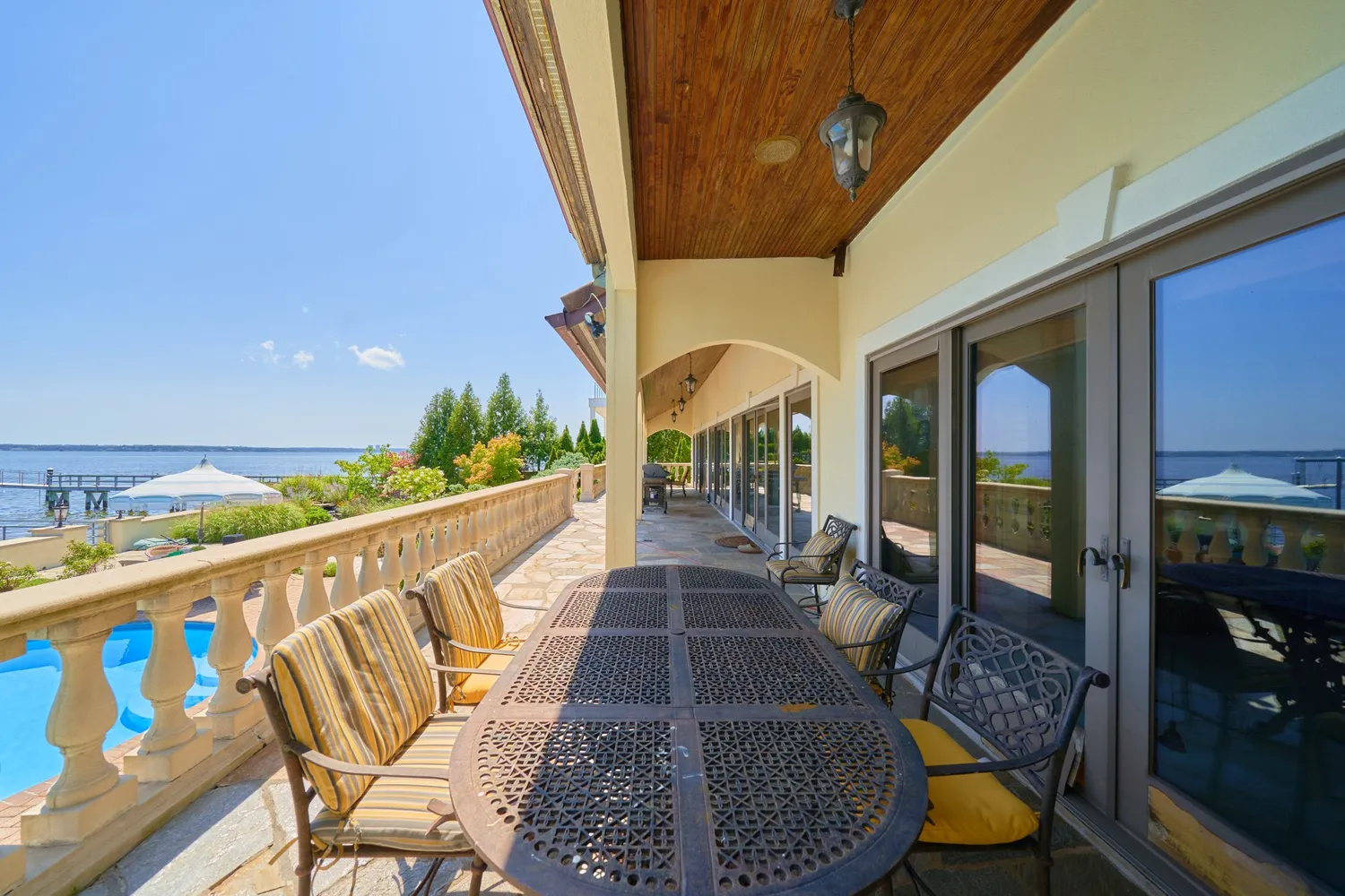 a view of a patio with couches under an umbrella