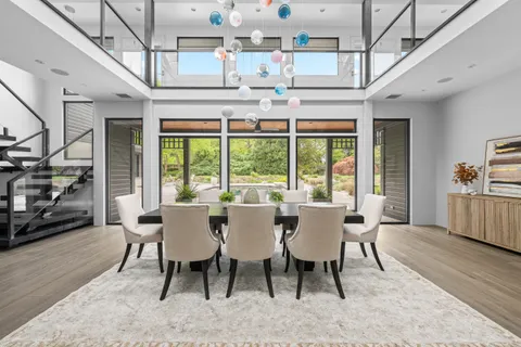 a view of a dining room with furniture large window and wooden floor