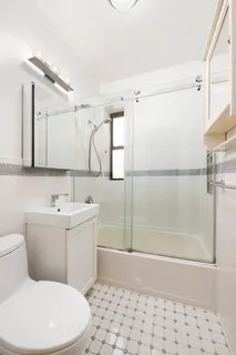a bathroom with a toilet sink and shower
