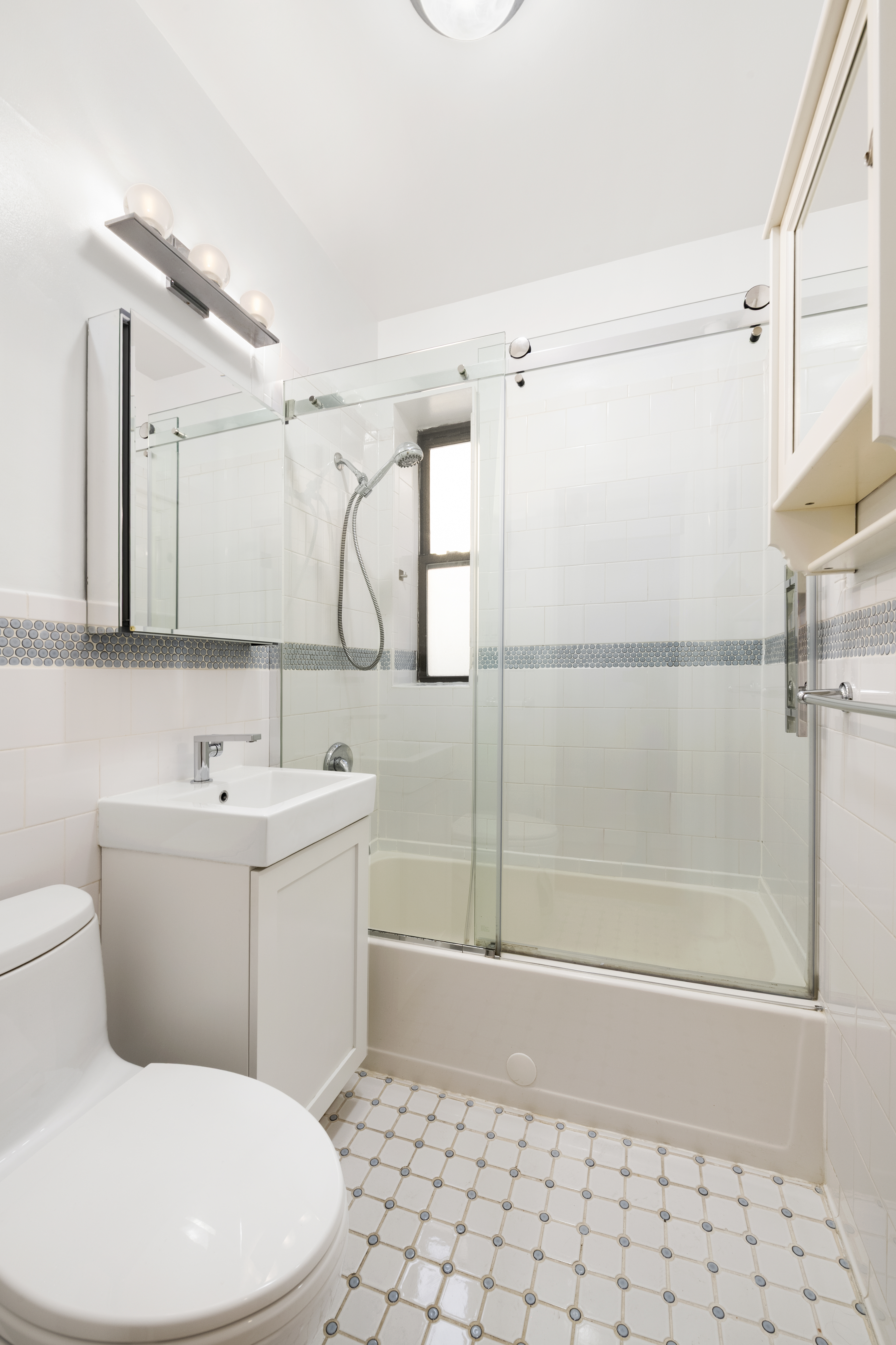 67 Morton Street, Unit 2A Manhattan, NY 10014 - Photo 8 of 10 a bathroom with a toilet sink and shower