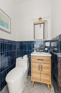 a bathroom with a toilet a sink and mirror