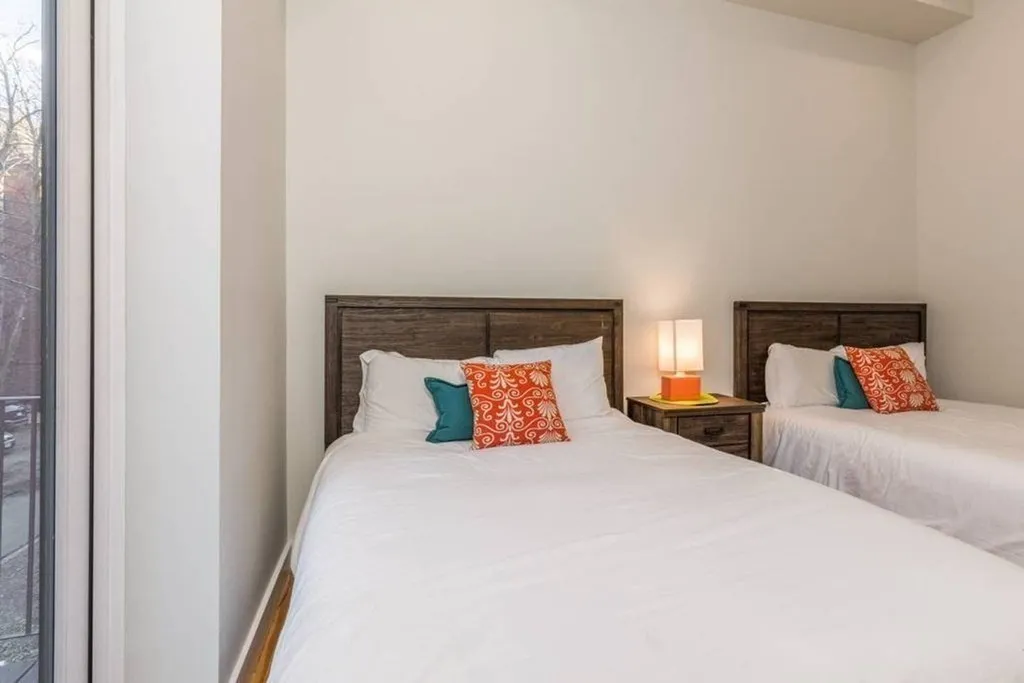 a bed room with a bed and a night stand