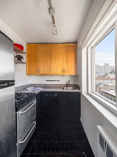 a kitchen with a sink stove and cabinets
