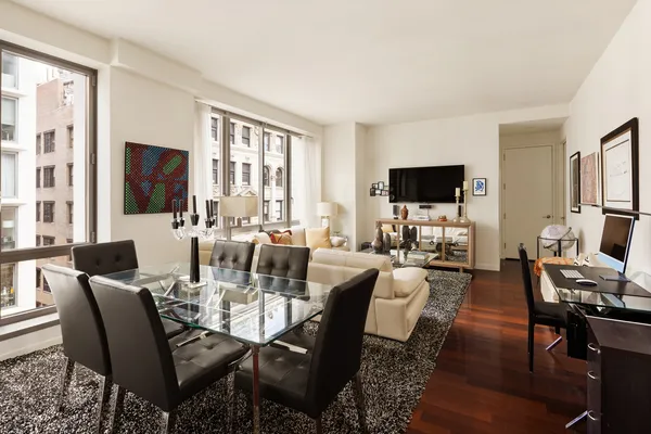 a view of a dining room with furniture window and wooden floor