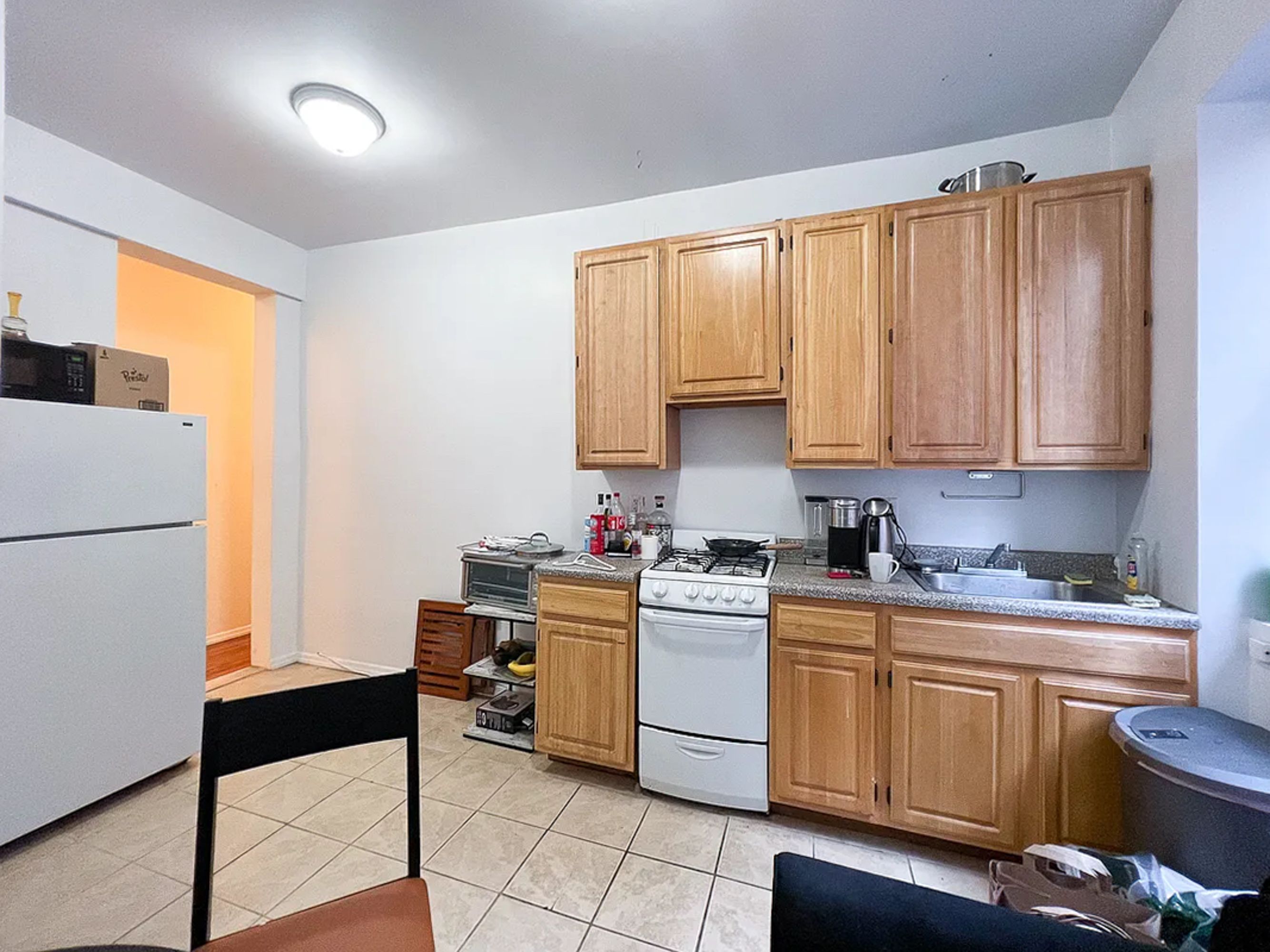 55 East 2nd Street, Unit 7 Manhattan, NY 10003 - Photo 6 of 18 a kitchen with a sink cabinets and appliances