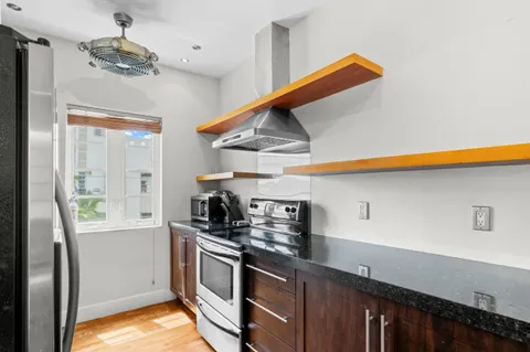 a kitchen with stainless steel appliances a sink a stove and a refrigerator