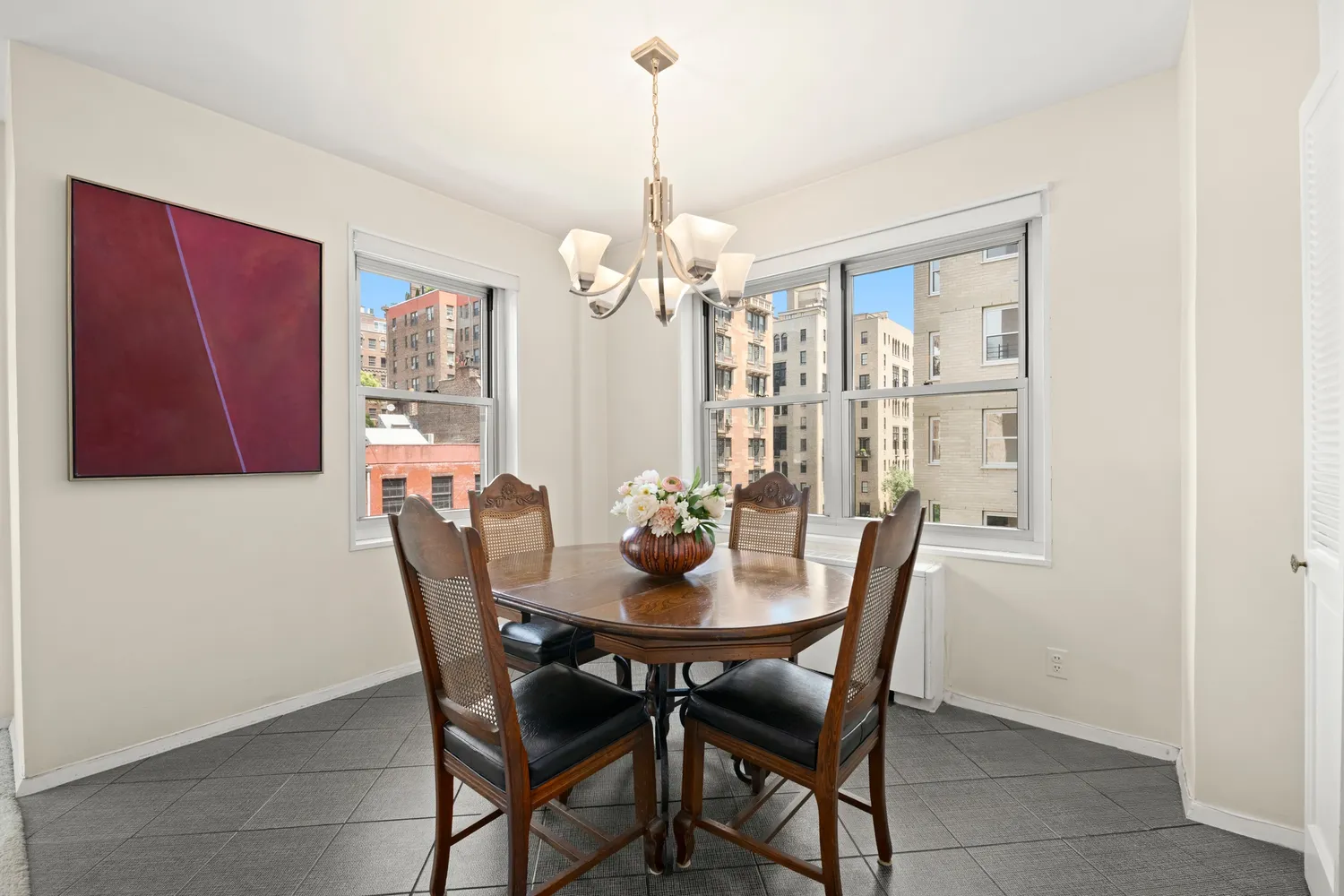 a view of a dining room with furniture and chandelier