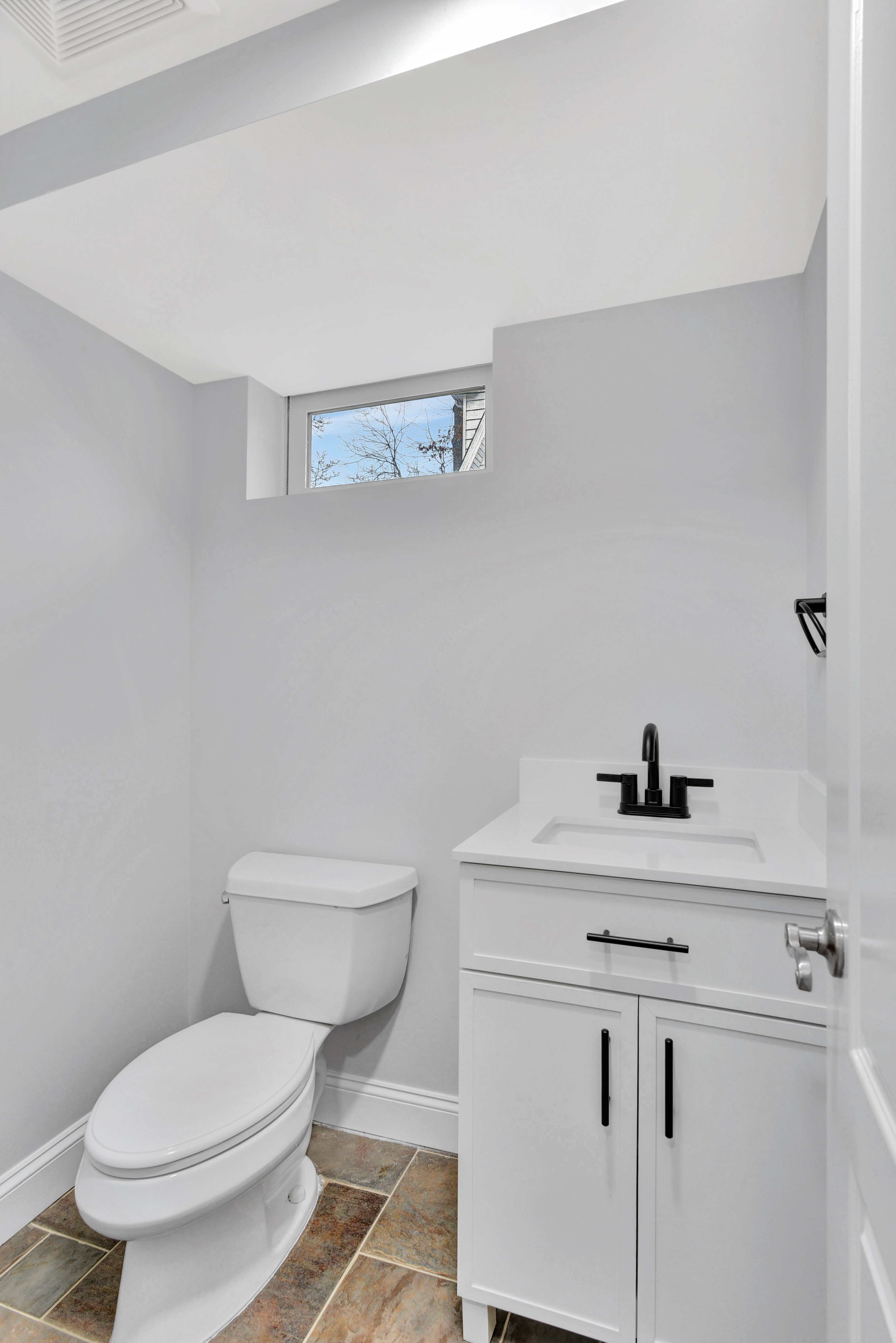 215 Lawrence Avenue Staten Island, NY 10310 - Photo 29 of 45 a bathroom with a granite countertop toilet sink and mirror