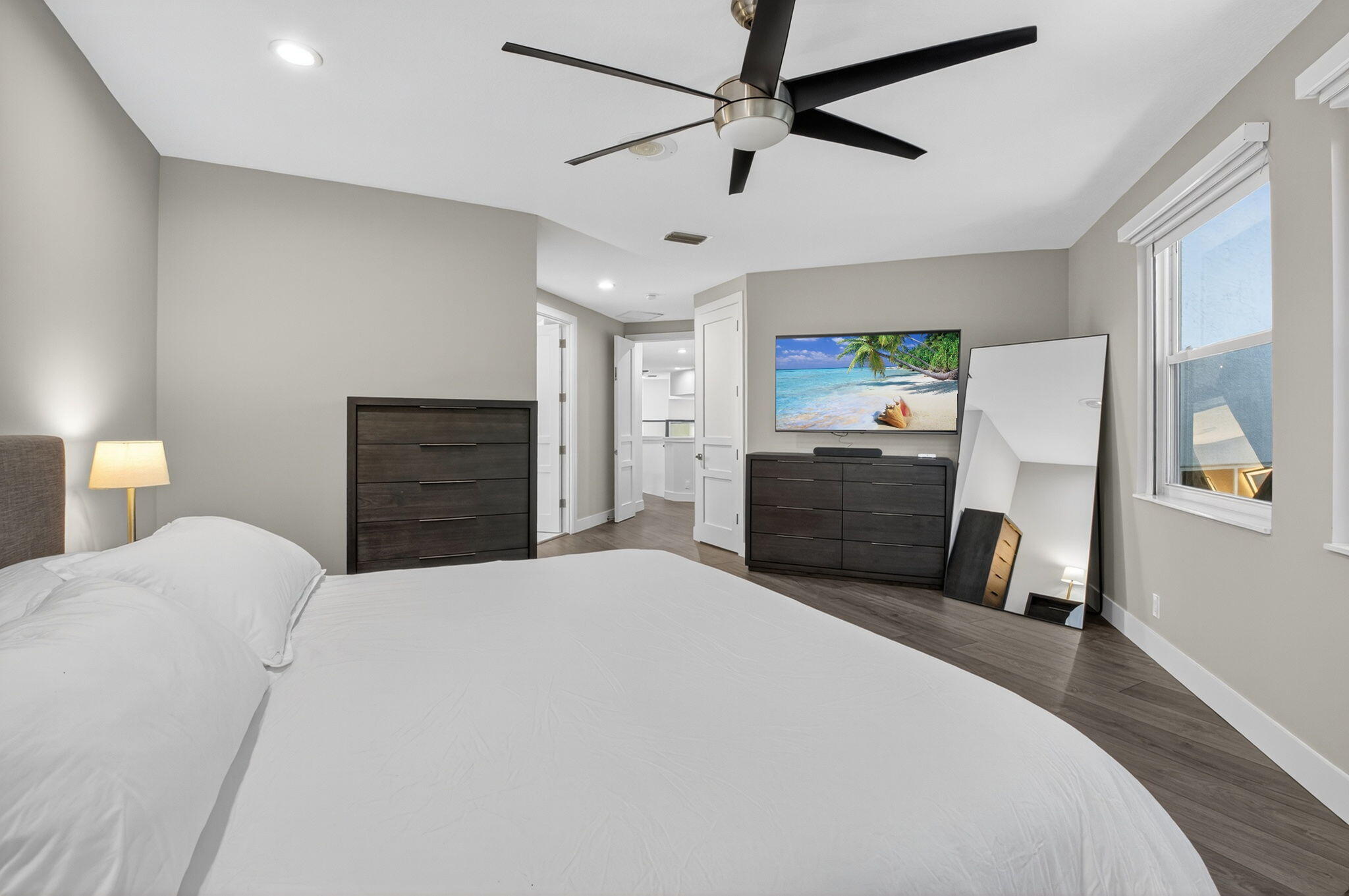 6529 Somerset Circle Boca Raton, FL 33496 - Photo 24 of 75 a bedroom with a bed and a chandelier