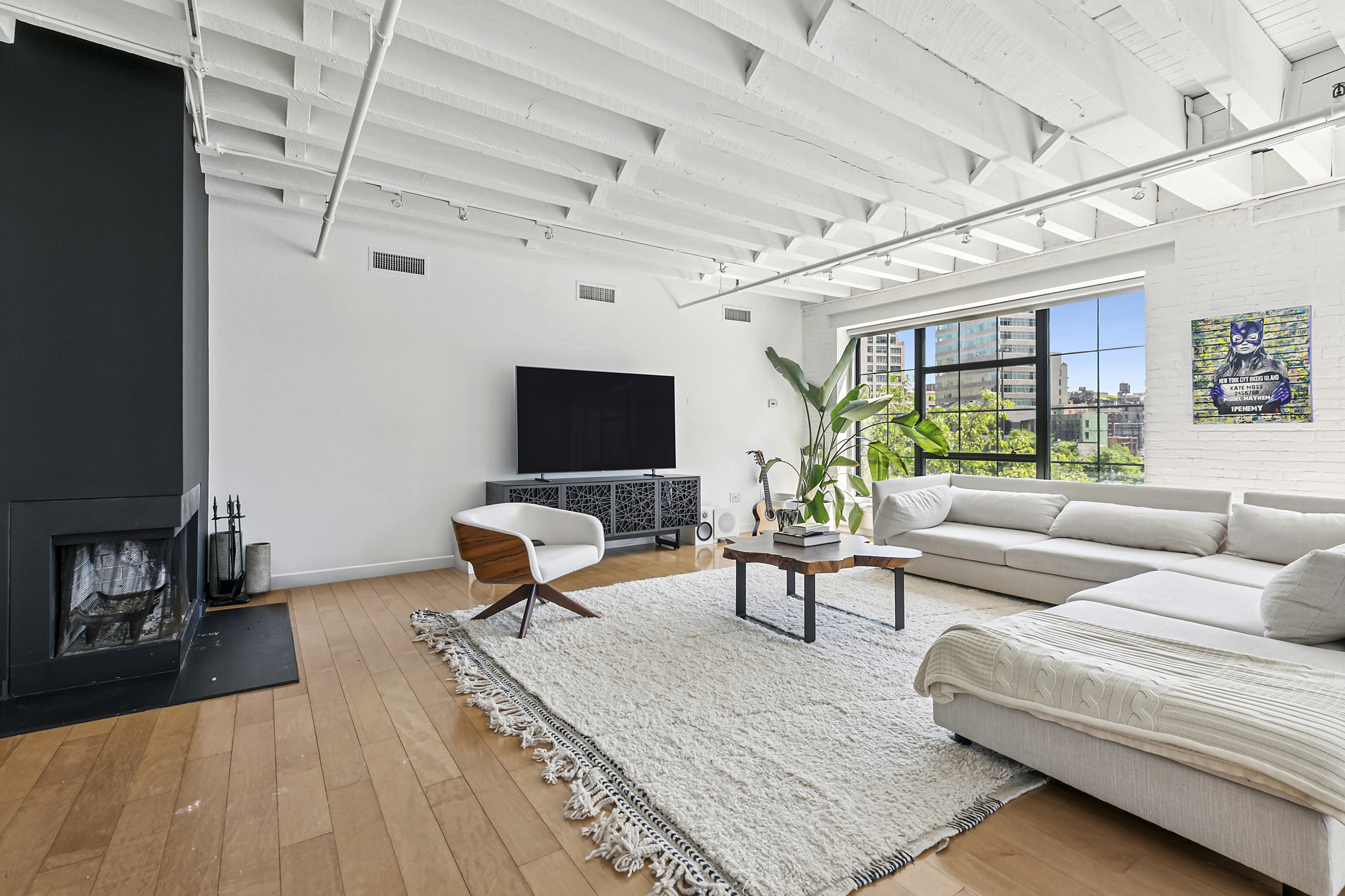 28 Laight Street, Unit 3B Manhattan, NY 10013 - Photo 4 of 11 a living room with furniture a flat screen tv and a table