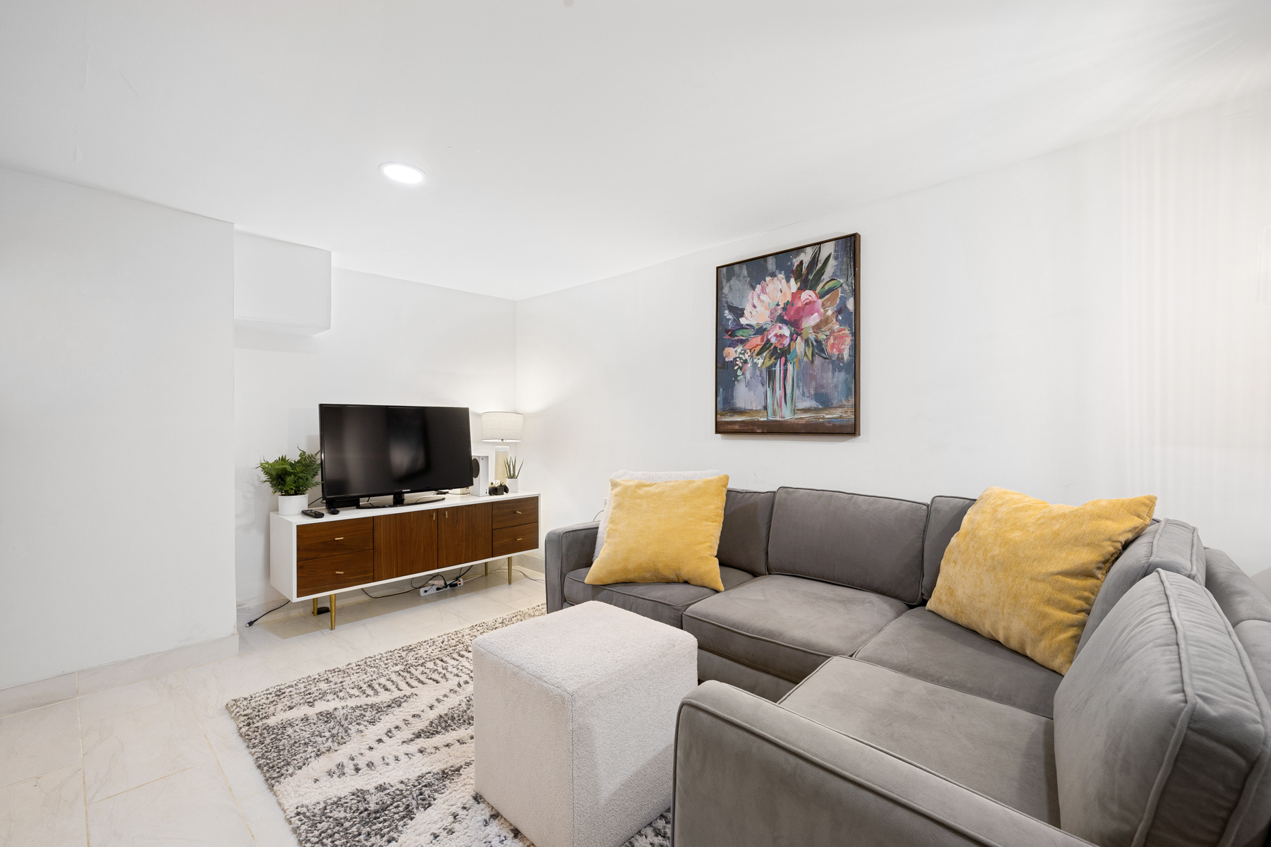 202 22nd Street Brooklyn, NY 11232 - Photo 25 of 28 a living room with furniture and a flat screen tv