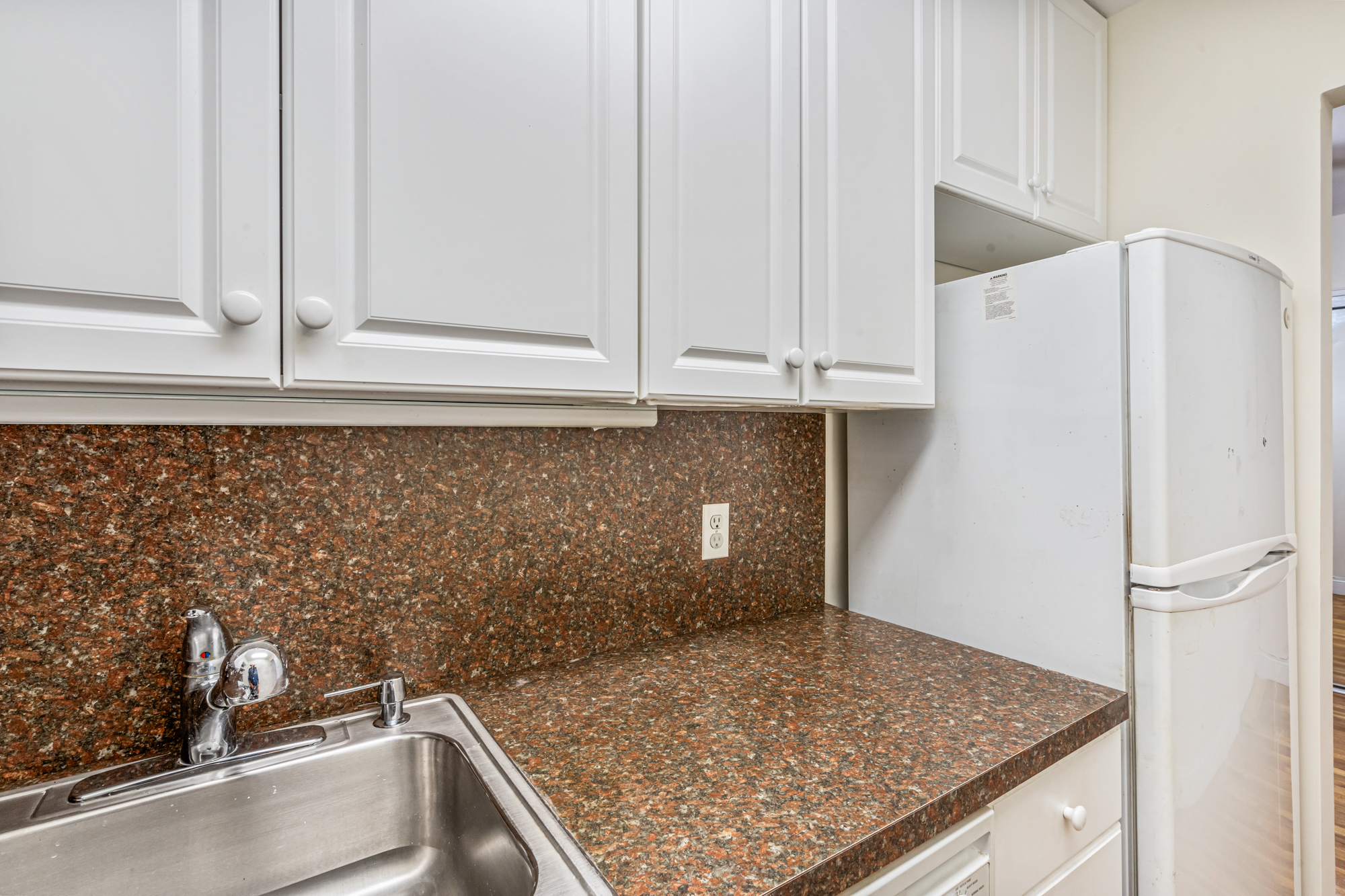 54-44 Little Neck Parkway, Unit 5G Queens, NY 11362 - Photo 9 of 20 a kitchen with a sink and cabinets