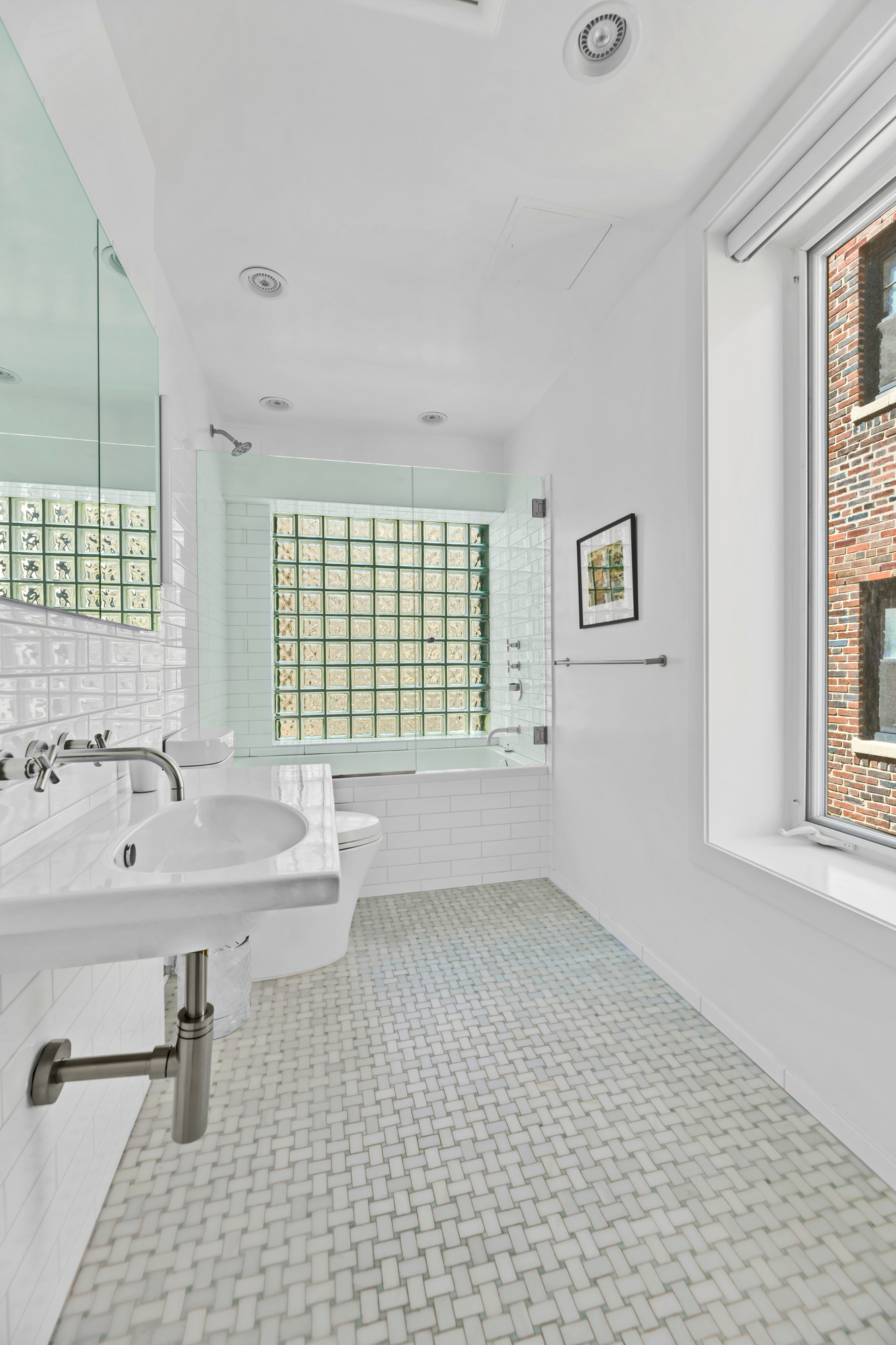 254 West 82nd Street, Unit 5A Manhattan, NY 10024 - Photo 9 of 18 a bathroom with a sink a toilet and a window