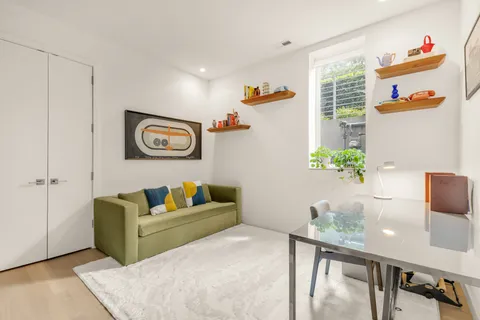 a living room with furniture and a potted plant