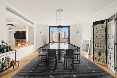 a view of a a dining room with furniture window and wooden floor