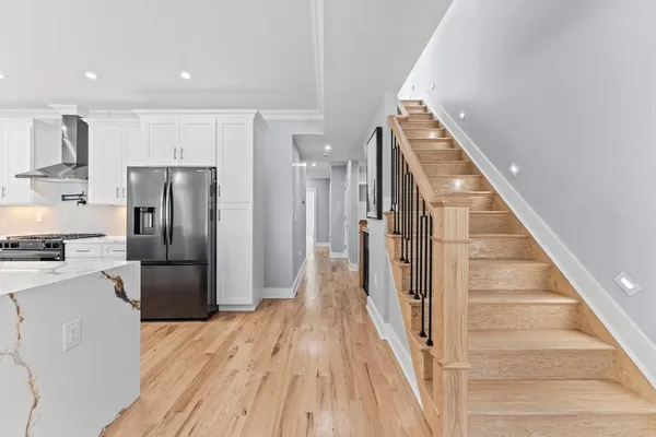 a view of a kitchen cabinets a refrigerator and a stove top oven