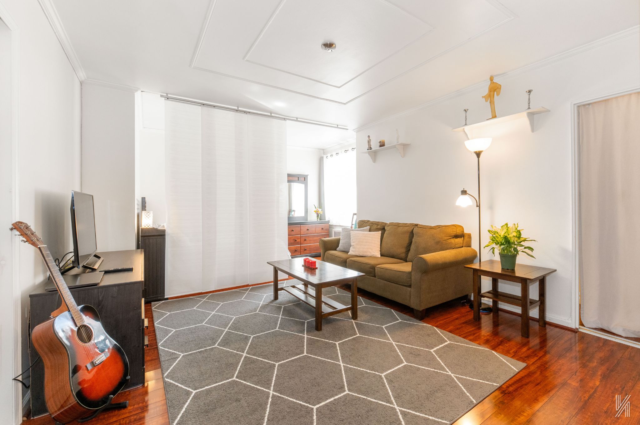 39-30 52nd Street, Unit 5E Queens, NY 11377 - Photo 2 of 15 a living room with furniture a table and a potted plant