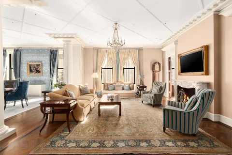 a living room with fireplace furniture and a flat screen tv