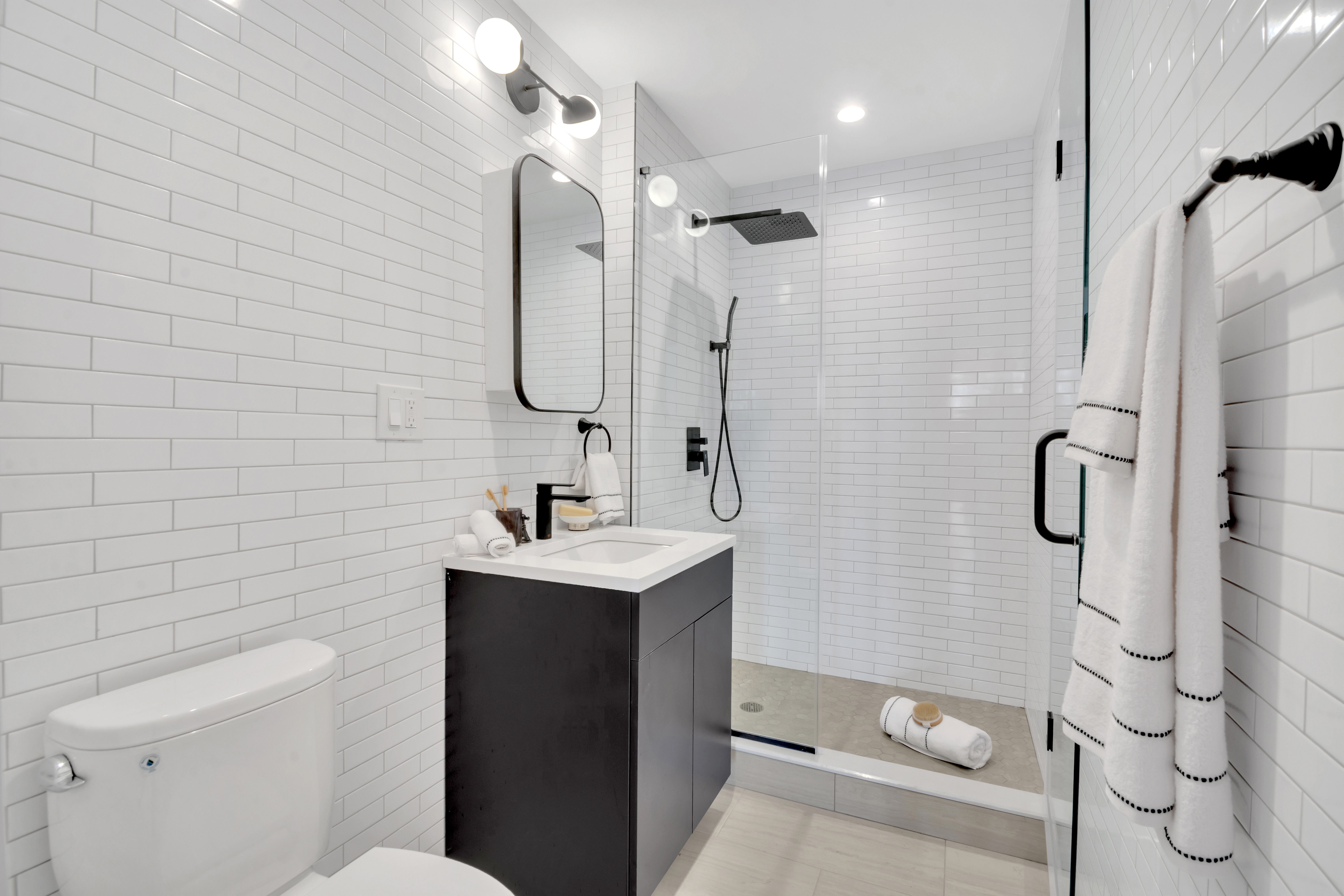 145 West 129th Street, Unit 4 Manhattan, NY 10027 - Photo 6 of 11 a bathroom with a sink a toilet and shower