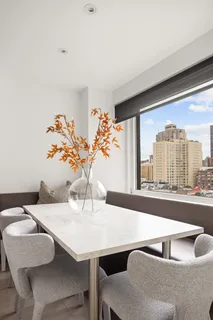 a dining room with furniture and window