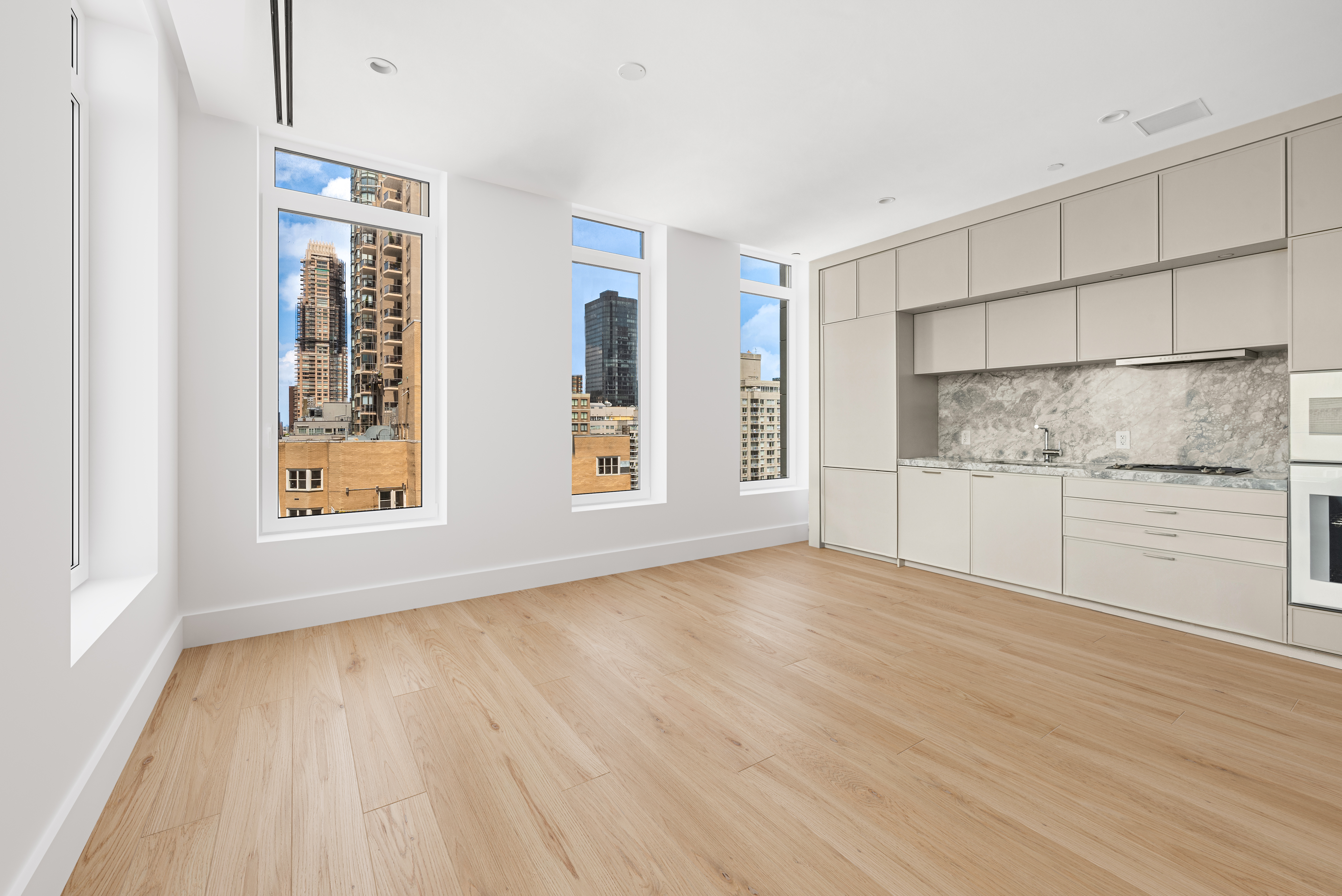 1059 3rd Avenue, Unit 18B Manhattan, NY 10065 - Photo 5 of 11 a view of an empty room with a window and wooden floor