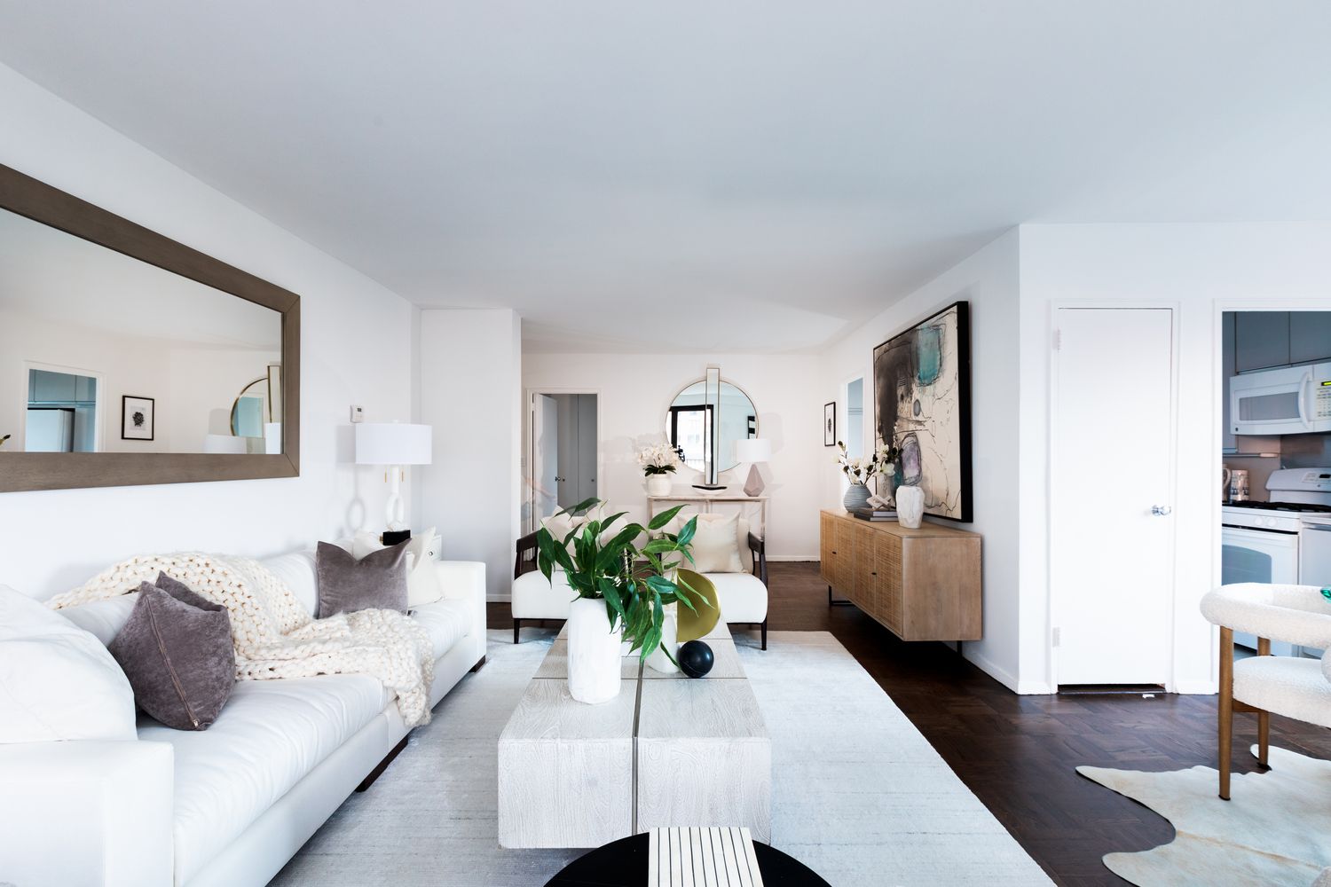 a living room with furniture and a potted plant