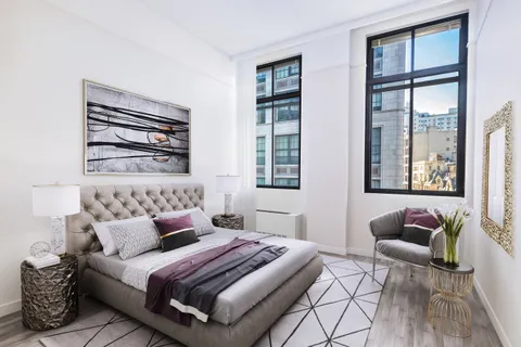 a bedroom with furniture and windows