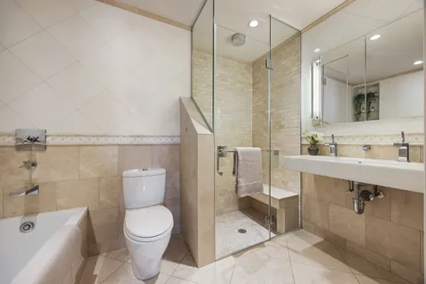a bathroom with a sink a toilet and shower