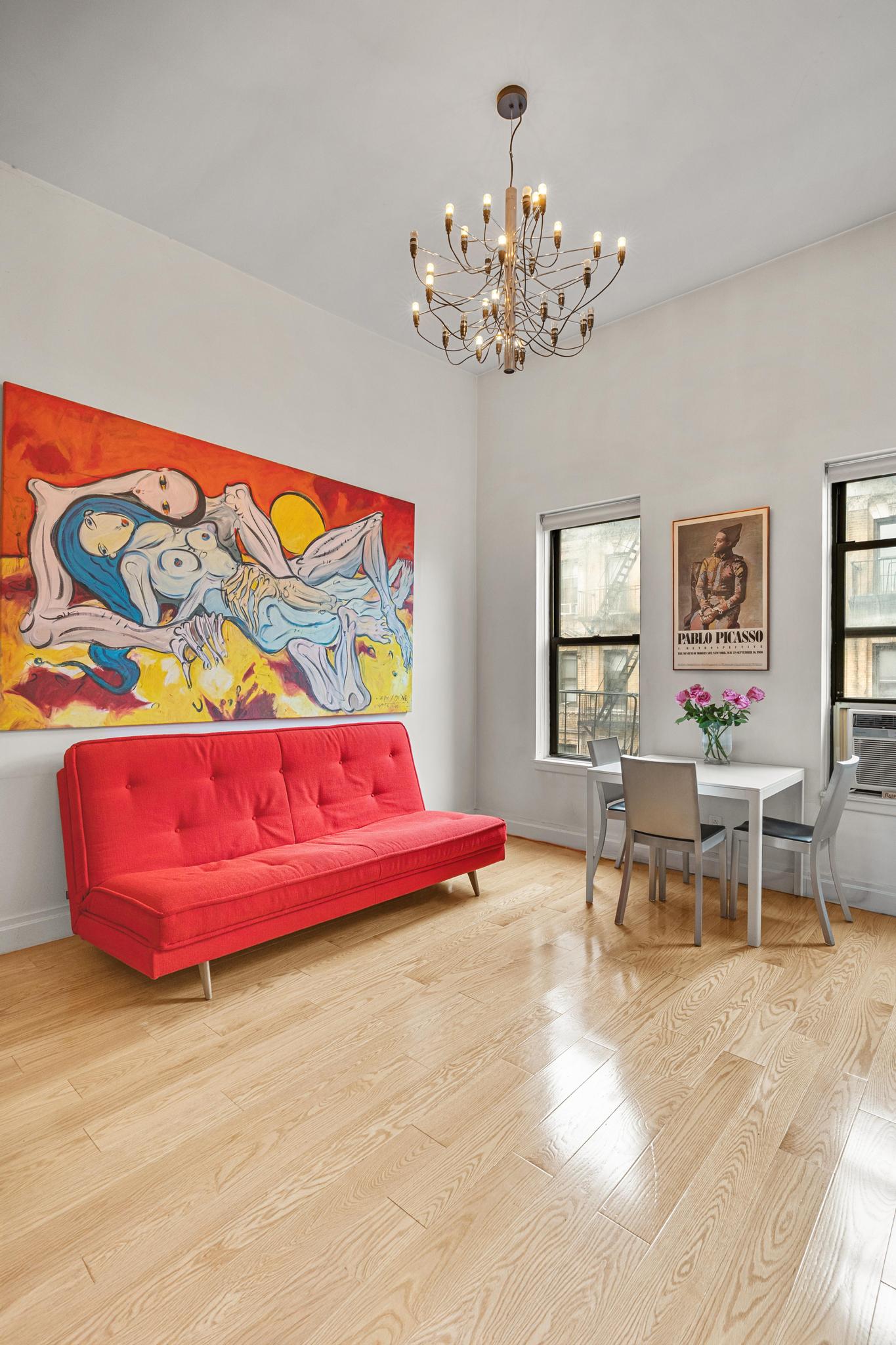 143 Sullivan Street, Unit 16 Manhattan, NY 10012 - Photo 4 of 10 a living room with a couch and a table