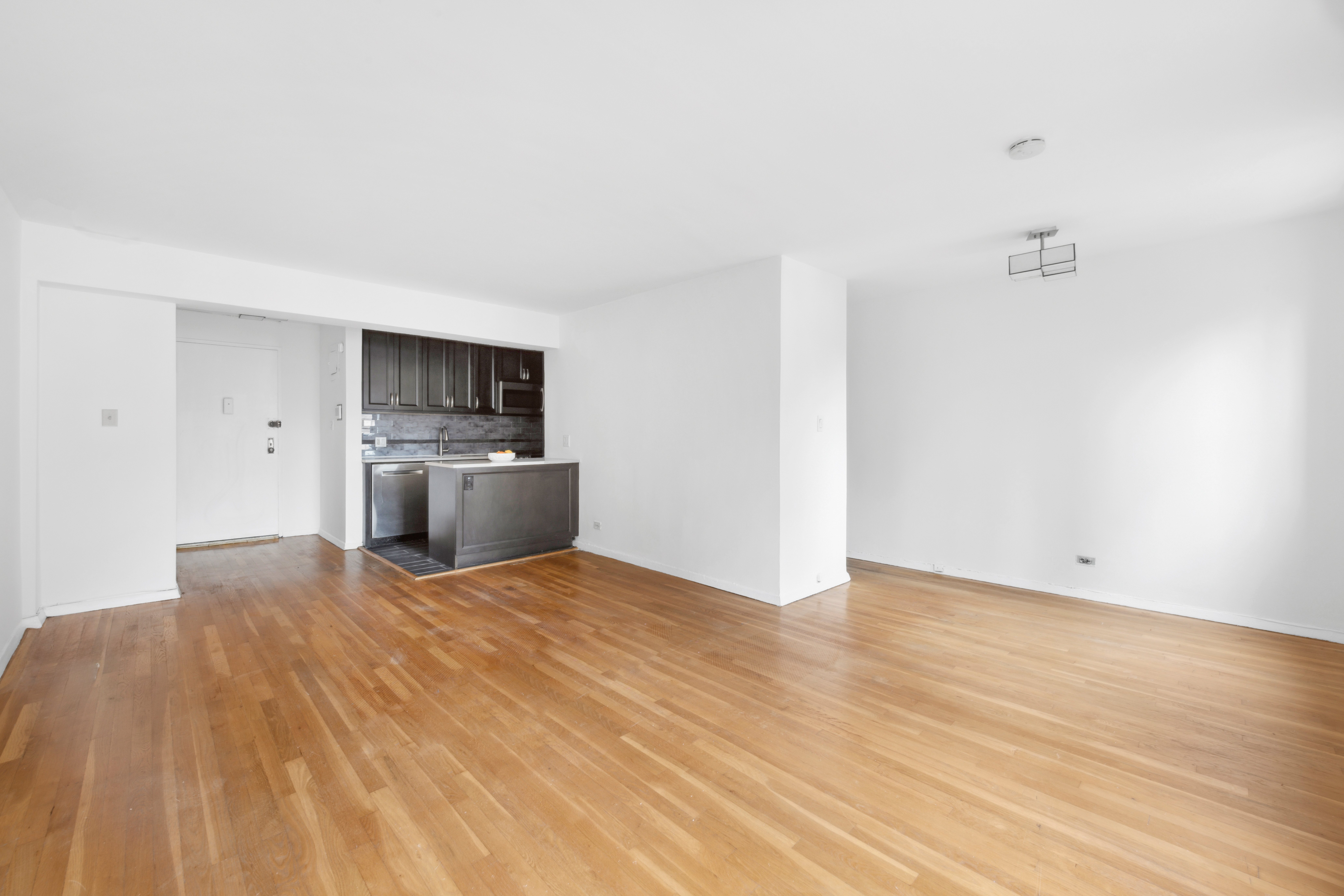 229 East 28th Street, Unit 6D Manhattan, NY 10016 - Photo 4 of 6 a view of a kitchen with a sink and a refrigerator