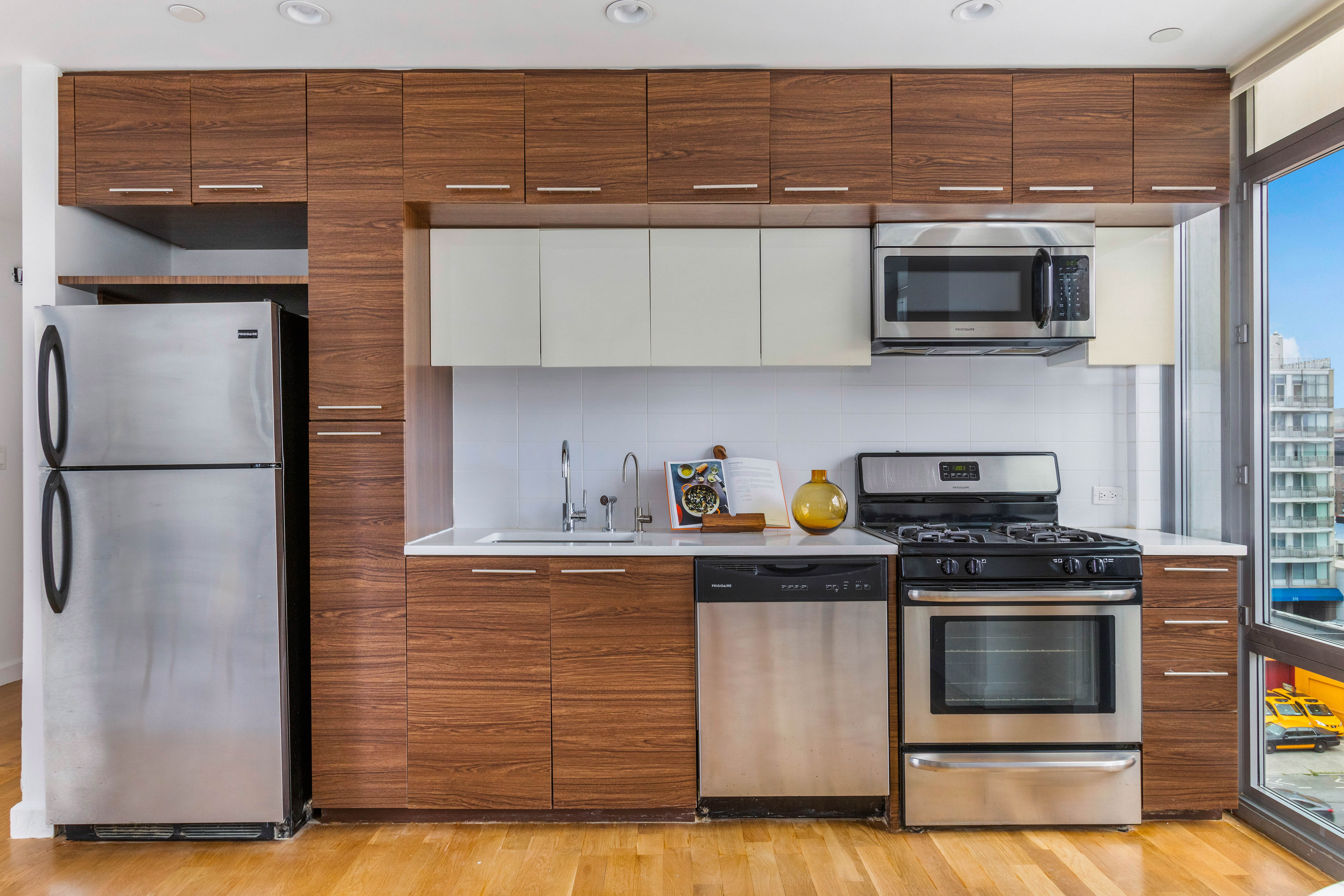 267 6th Street, Unit PHG Brooklyn, NY 11215 - Photo 4 of 17 a kitchen with stainless steel appliances granite countertop a stove and a microwave