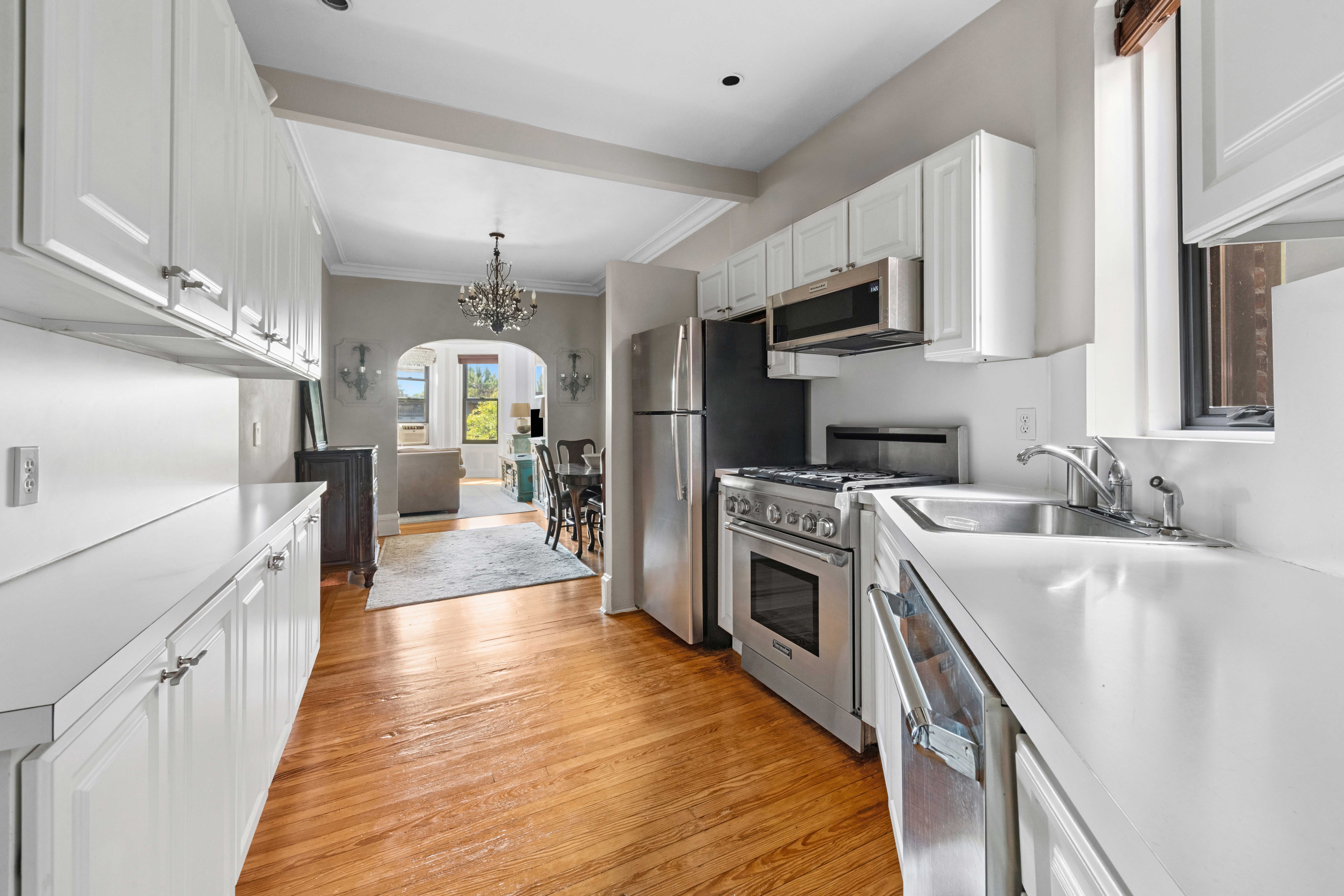 a kitchen with stainless steel appliances granite countertop a sink stove and refrigerator