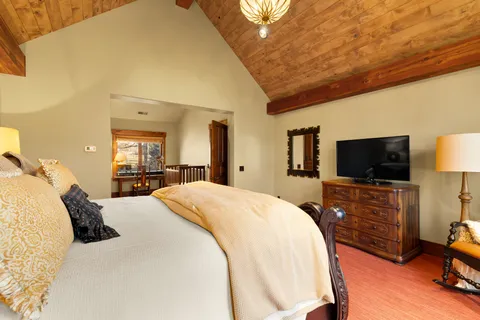 a bedroom with furniture and a large window