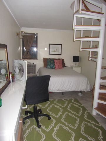 126 East 83rd Street, Unit A2 Manhattan, NY 10028 - Photo 4 of 5 a bed room with a bed window and table