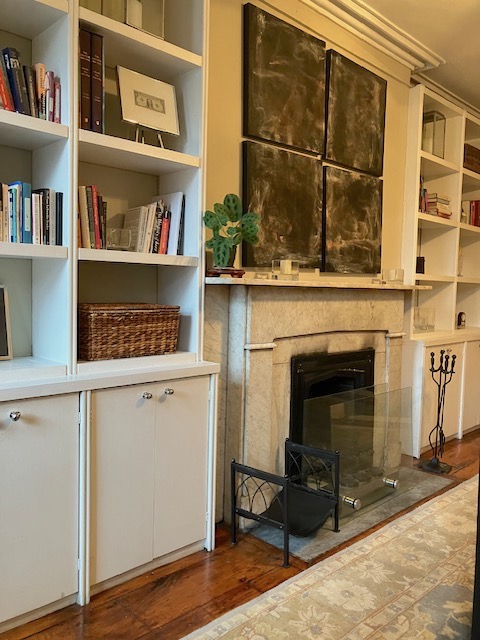 214 East 12th Street, Unit 4 Manhattan, NY 10003 - Photo 5 of 9 a living room with a book shelf and a fireplace