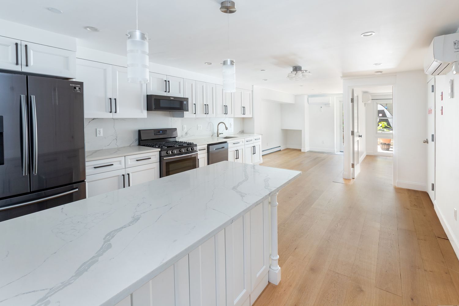 a kitchen with stainless steel appliances a refrigerator stove microwave and cabinets