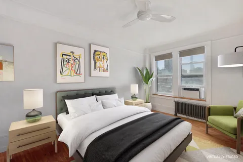 a bedroom with a bed couch and window