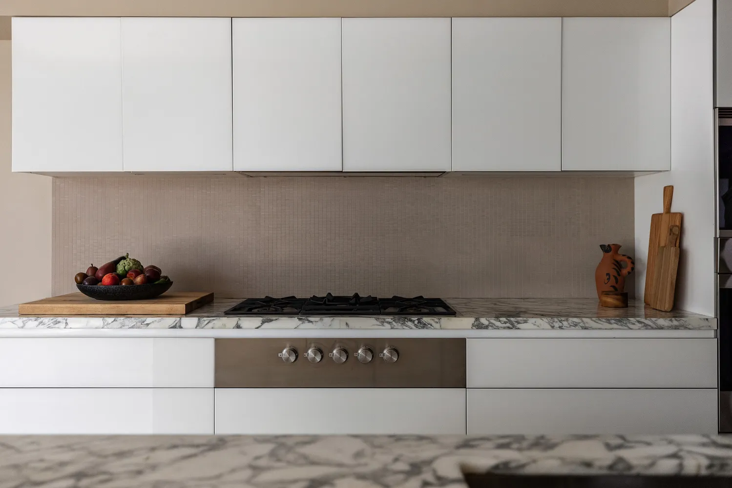 a kitchen with white cabinets and sink