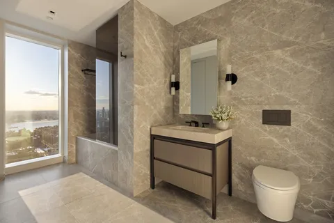 a bathroom with a toilet sink and mirror