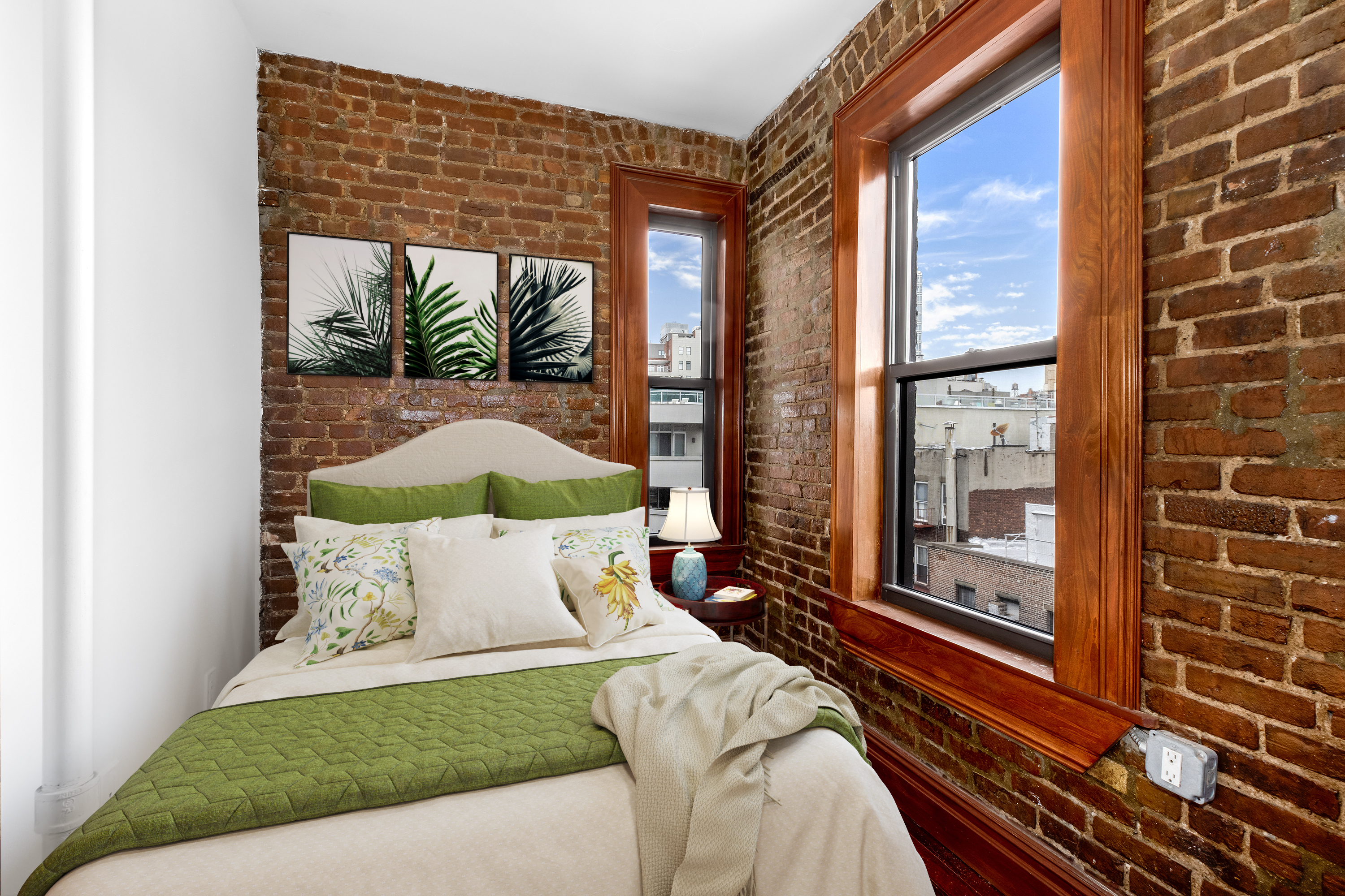 117 Mulberry Street, Unit 21 Manhattan, NY 10013 - Photo 3 of 4 a bed sitting in a bedroom next to a window