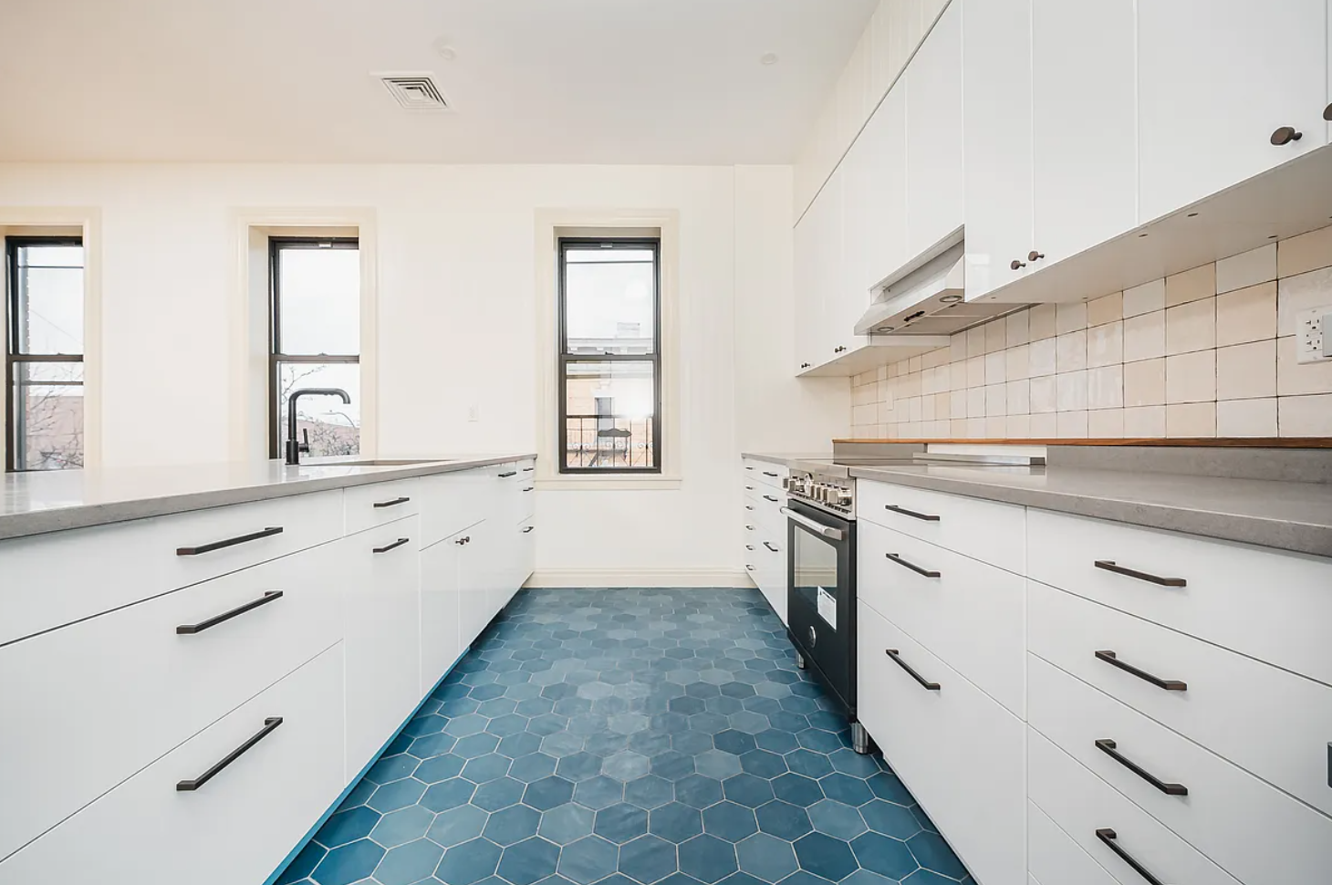 68-38 Forest Avenue, Unit 3R Queens, NY 11385 - Photo 2 of 15 a kitchen with granite countertop white cabinets and white appliances