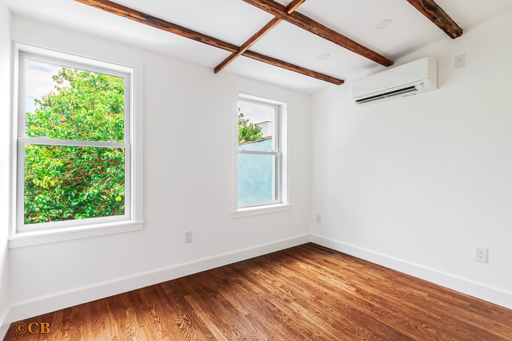 221 Gates Avenue, Unit 2 Brooklyn, NY 11238 - Photo 4 of 7 a view of an empty room with wooden floor and a window