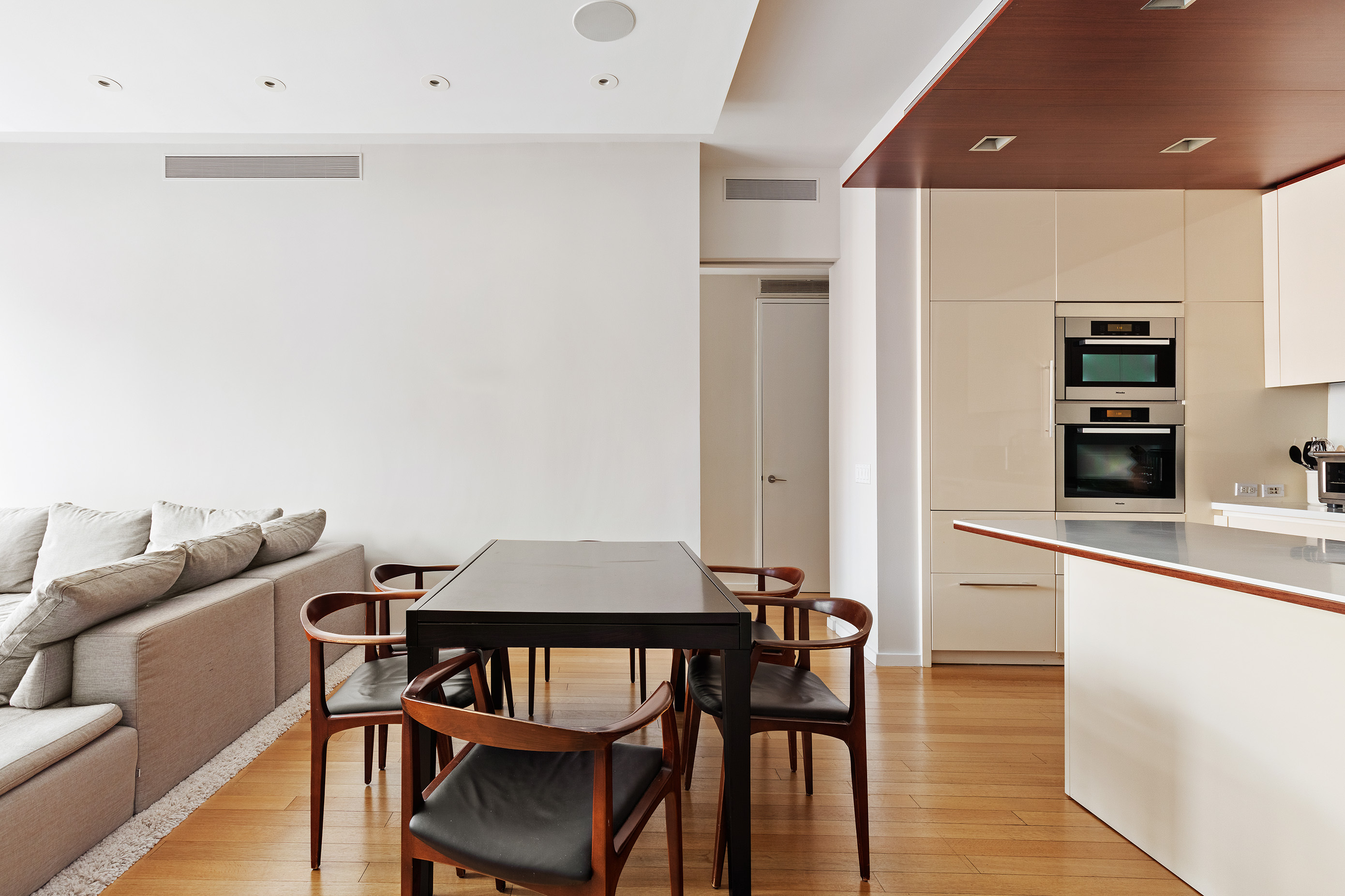 122 Greenwich Avenue, Unit 6 Manhattan, NY 10011 - Photo 3 of 13 a kitchen with stainless steel appliances granite countertop a dining table chairs and view living room